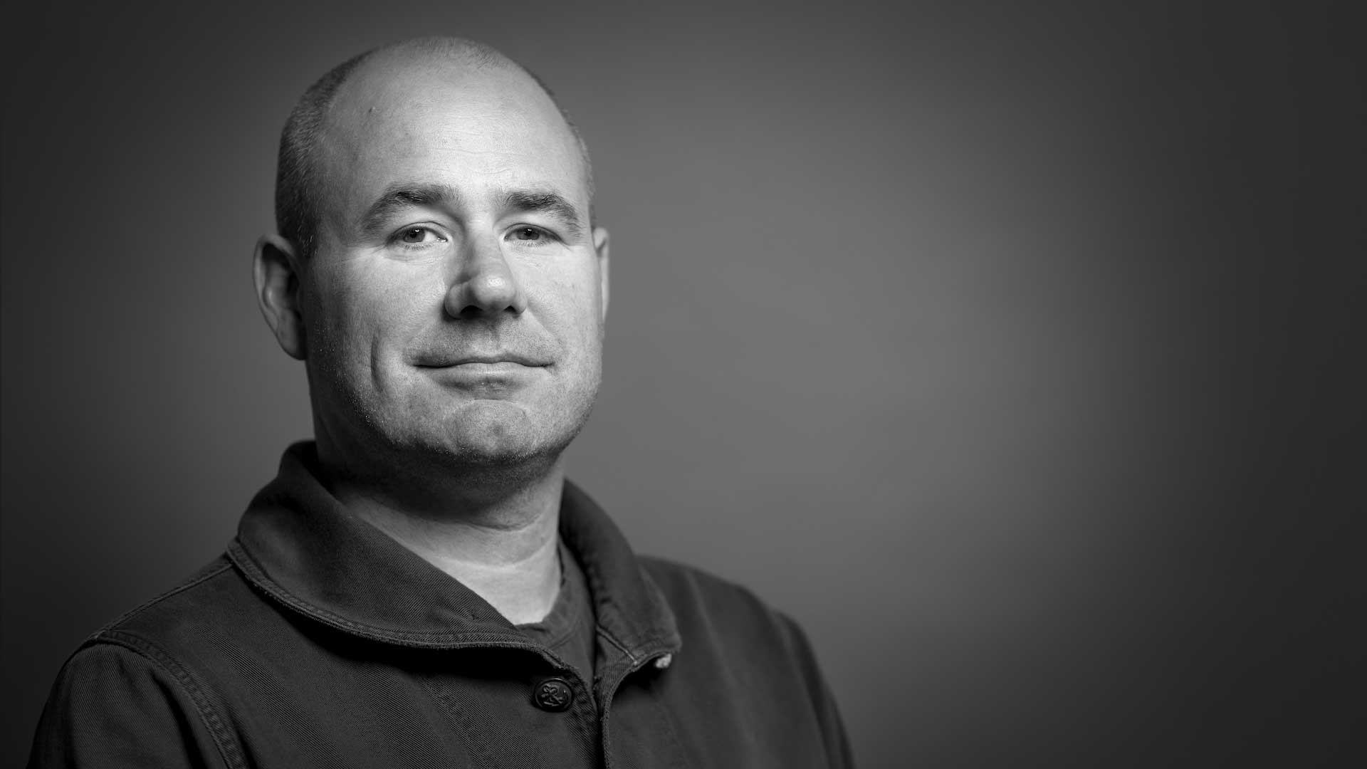 A black and white photo of James Razzall