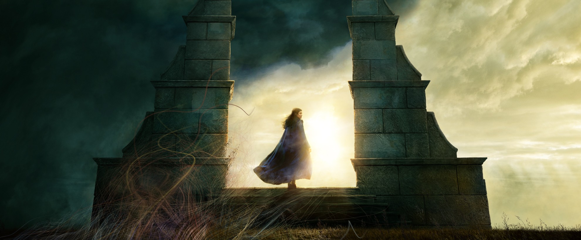 Rosamund Pike stands in a large stone archway