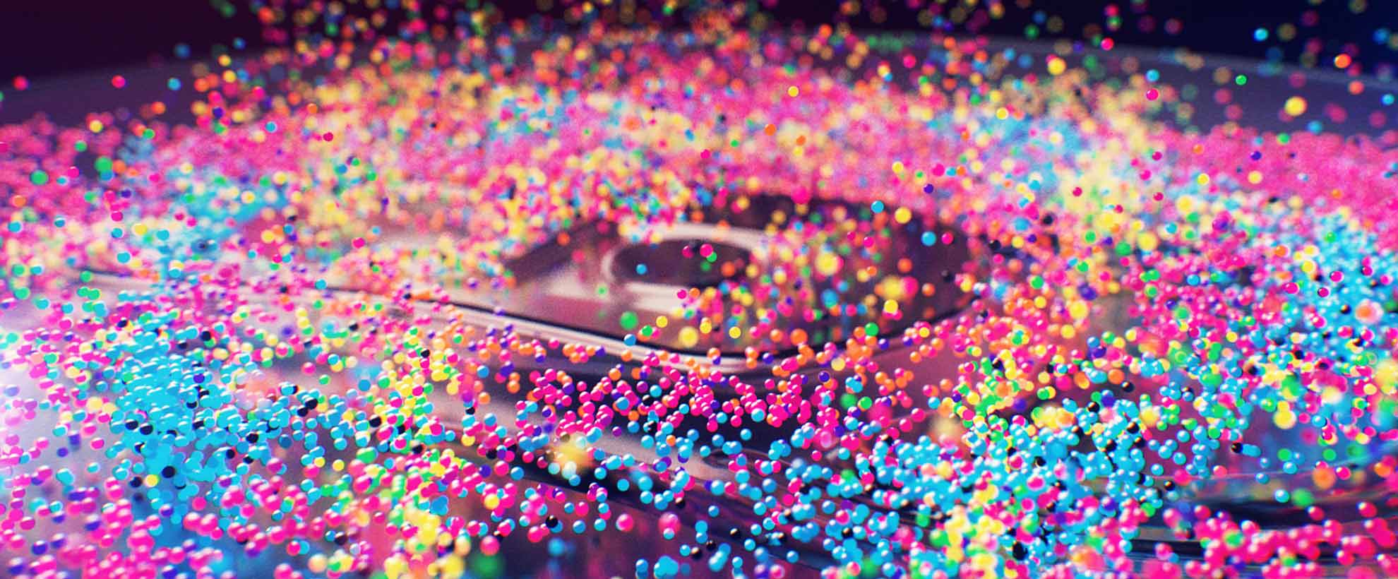 A speaker with animated multicoloured bubbles on it bouncing them up against a black background.