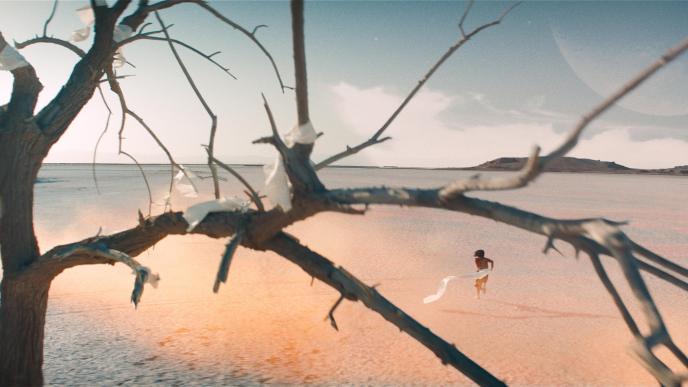 back view of person behind of a dead tree wrapped in receipts