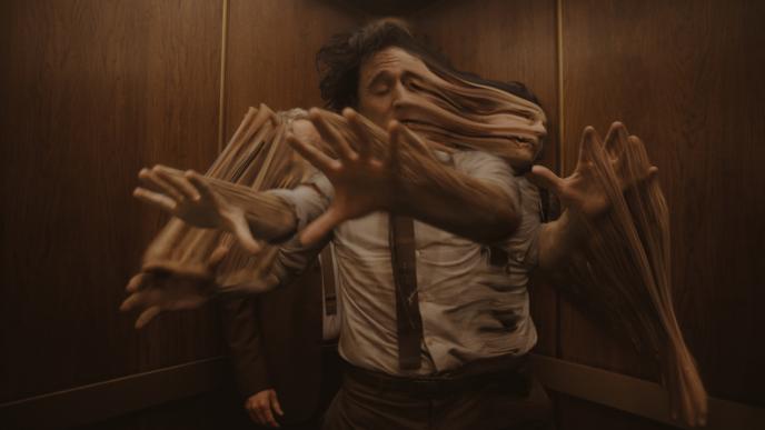 Visual Development of Tom Hiddleston as Loki, time slipping in a brown elevator. 