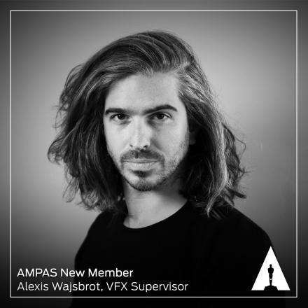 A black and white headshot of a man with long hair, there is the Academy logo in the bottom right. 